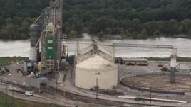5.7K aerial stock footage a reverse view of storage tanks and grain elevator by river, Council Bluffs, Iowa Aerial Stock Footage | DX0002_170_008