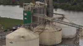 5.7K aerial stock footage approach storage tanks and grain elevator by river, Council Bluffs, Iowa Aerial Stock Footage | DX0002_170_009