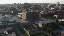 5.7K aerial stock footage of approaching a brick office building at sunset, Downtown Omaha, Nebraska Aerial Stock Footage | DX0002_170_046