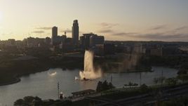 5.7K aerial stock footage ascending away from a fountain with view of skyline at sunset, Downtown Omaha, Nebraska Aerial Stock Footage | DX0002_172_008