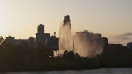 5.7K aerial stock footage focus on skyscraper while flying by fountain at sunset, Downtown Omaha, Nebraska Aerial Stock Footage | DX0002_172_015