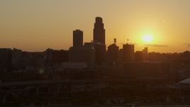 5.7K aerial stock footage orbit skyscraper and skyline with view of setting sun, Downtown Omaha, Nebraska Aerial Stock Footage | DX0002_172_023