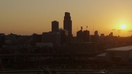 5.7K aerial stock footage orbit skyscraper and skyline with setting sun in background, Downtown Omaha, Nebraska Aerial Stock Footage | DX0002_172_025