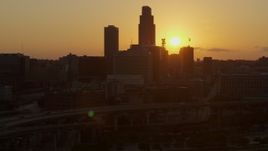 5.7K aerial stock footage slowly circle skyscraper and skyline with setting sun in background, Downtown Omaha, Nebraska Aerial Stock Footage | DX0002_172_026