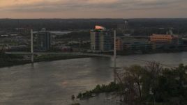 5.7K aerial stock footage of a pedestrian bridge spanning the Missouri River at sunset, Omaha, Nebraska Aerial Stock Footage | DX0002_172_027