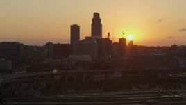 5.7K aerial stock footage slowly orbit the skyline, setting sun in background, Downtown Omaha, Nebraska Aerial Stock Footage | DX0002_172_031
