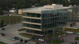 5.7K aerial stock footage of a reverse view of a modern office building at sunset in Council Bluffs, Iowa Aerial Stock Footage | DX0002_172_035