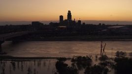 5.7K aerial stock footage a view of the skyline while descending by the river at twilight, Downtown Omaha, Nebraska Aerial Stock Footage | DX0002_172_044
