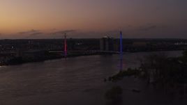 5.7K aerial stock footage of flying away from a pedestrian bridge spanning the Missouri River at twilight, Omaha, Nebraska Aerial Stock Footage | DX0002_172_050
