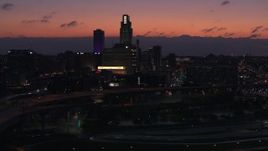 5.7K aerial stock footage reverse view of skyscrapers in the skyline at twilight, Downtown Omaha, Nebraska Aerial Stock Footage | DX0002_173_002