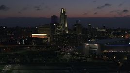 5.7K aerial stock footage reverse view and flyby the city's skyline at twilight, Downtown Omaha, Nebraska Aerial Stock Footage | DX0002_173_012