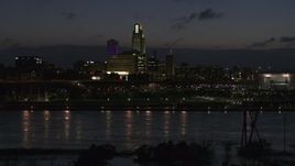 5.7K aerial stock footage fly low over the river toward the city's skyline at twilight, Downtown Omaha, Nebraska Aerial Stock Footage | DX0002_173_013