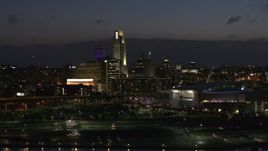 5.7K aerial stock footage of passing by the city's skyline at twilight, Downtown Omaha, Nebraska Aerial Stock Footage | DX0002_173_015
