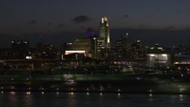 5.7K aerial stock footage ascend and fly past the city's skyline at twilight, Downtown Omaha, Nebraska Aerial Stock Footage | DX0002_173_017