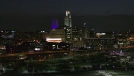 5.7K aerial stock footage fly away from the city's skyline at night, seen from river, Downtown Omaha, Nebraska Aerial Stock Footage | DX0002_173_031