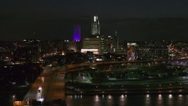 5.7K aerial stock footage follow bridge to approach the city's skyline at night, Downtown Omaha, Nebraska Aerial Stock Footage | DX0002_173_035
