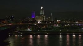 5.7K aerial stock footage fly over river to approach the city's skyline at night, Downtown Omaha, Nebraska Aerial Stock Footage | DX0002_173_036