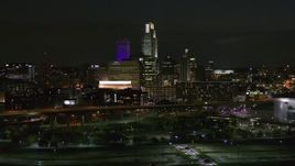 5.7K aerial stock footage fly away from city's skyline at night, reveal the river, Downtown Omaha, Nebraska Aerial Stock Footage | DX0002_173_037