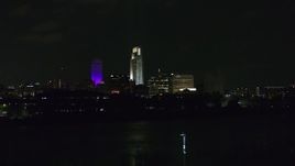 5.7K aerial stock footage ascend toward tall skyscrapers at night, Downtown Omaha, Nebraska Aerial Stock Footage | DX0002_173_038