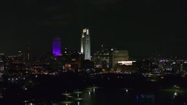 5.7K aerial stock footage of slowly flying by tall skyscrapers at night, Downtown Omaha, Nebraska Aerial Stock Footage | DX0002_173_039