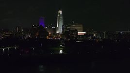 5.7K aerial stock footage descend and slowly fly past tall skyscrapers at night, Downtown Omaha, Nebraska Aerial Stock Footage | DX0002_173_041