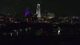 5.7K aerial stock footage of a reverse view of tall skyscrapers at night, Downtown Omaha, Nebraska Aerial Stock Footage | DX0002_173_050
