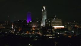 5.7K aerial stock footage of focusing on towering skyscrapers at night, Downtown Omaha, Nebraska Aerial Stock Footage | DX0002_173_055