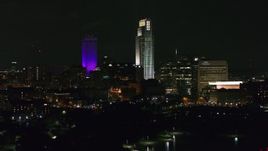 5.7K aerial stock footage the city's skyscrapers seen from the park at night, Downtown Omaha, Nebraska Aerial Stock Footage | DX0002_173_060
