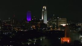 5.7K aerial stock footage fly away from city's skyscrapers and the park fountain at night, Downtown Omaha, Nebraska Aerial Stock Footage | DX0002_173_064