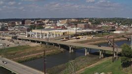5.7K aerial stock footage descend by bridges with view of warehouses and downtown, Sioux City, Iowa Aerial Stock Footage | DX0002_174_011