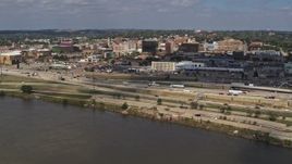 5.7K aerial stock footage of office buildings and I-29 seen while descending by the river, Downtown Sioux City, Iowa Aerial Stock Footage | DX0002_174_015