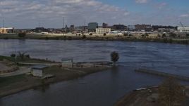 5.7K aerial stock footage fly low over river, ascend for view of Downtown Sioux City, Iowa Aerial Stock Footage | DX0002_174_021