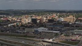 5.7K aerial stock footage reverse view of office buildings in Downtown Sioux City, Iowa, descend toward river Aerial Stock Footage | DX0002_174_030