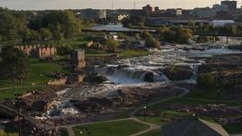 5.7K aerial stock footage of circling the falls at Falls Park at sunset in Sioux Falls, South Dakota Aerial Stock Footage | DX0002_176_003