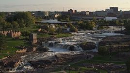 5.7K aerial stock footage of the waterfalls at Falls Park at sunset in Sioux Falls, South Dakota Aerial Stock Footage | DX0002_176_004