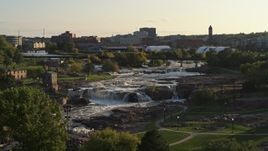 5.7K aerial stock footage of orbiting the waterfalls at Falls Park at sunset in Sioux Falls, South Dakota Aerial Stock Footage | DX0002_176_005