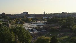 5.7K aerial stock footage ascend and reveal the waterfalls at Falls Park at sunset in Sioux Falls, South Dakota Aerial Stock Footage | DX0002_176_006
