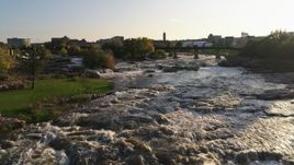 5.7K aerial stock footage of a reverse view of waterfalls at sunset in Sioux Falls, South Dakota Aerial Stock Footage | DX0002_176_011