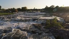 5.7K aerial stock footage fly over the waterfalls at sunset in Sioux Falls, South Dakota Aerial Stock Footage | DX0002_176_013