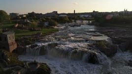 5.7K aerial stock footage reverse view of waterfalls on Big Sioux River at sunset in Sioux Falls, South Dakota Aerial Stock Footage | DX0002_176_021