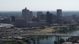 5.7K aerial stock footage of the city's skyline seen while flying by a bridge in Downtown Memphis, Tennessee Aerial Stock Footage | DX0002_177_003