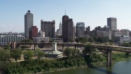 5.7K aerial stock footage ascend over river toward office towers in the Downtown Memphis, Tennessee skyline Aerial Stock Footage | DX0002_178_011