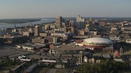 5.7K aerial stock footage of a view of the city skyline seen while flying by FedEx Forum arena at sunset, Downtown Memphis, Tennessee Aerial Stock Footage | DX0002_180_024