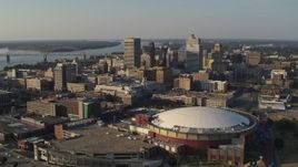 5.7K aerial stock footage ascend and approach the city skyline and FedEx Forum arena at sunset, Downtown Memphis, Tennessee Aerial Stock Footage | DX0002_180_028