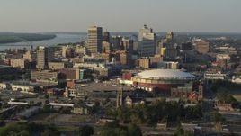 5.7K aerial stock footage flying away from FedEx Forum arena while focused on the skyline at sunset, Downtown Memphis, Tennessee Aerial Stock Footage | DX0002_180_033