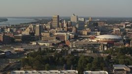 5.7K aerial stock footage passing FedEx Forum arena while focused on the skyline at sunset, Downtown Memphis, Tennessee Aerial Stock Footage | DX0002_180_034