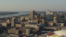 5.7K aerial stock footage of office towers at sunset, seen while passing the arena, Downtown Memphis, Tennessee Aerial Stock Footage | DX0002_180_042