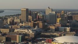 5.7K aerial stock footage of office towers at sunset, seen while passing roof of the arena, Downtown Memphis, Tennessee Aerial Stock Footage | DX0002_181_001
