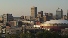 5.7K aerial stock footage of One Commerce Square office tower at sunset, descend by arena, Downtown Memphis, Tennessee Aerial Stock Footage | DX0002_181_009