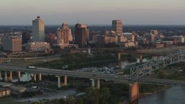 5.7K aerial stock footage flyby the city's skyline behind the bridge and the river at sunset, Downtown Memphis, Tennessee Aerial Stock Footage | DX0002_181_014